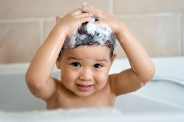 boy washing hair in bathtub