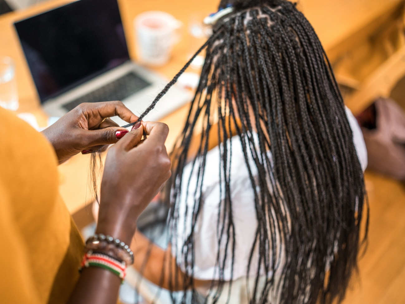 woman getting braided hair extensions