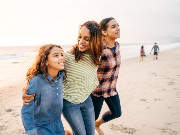 mother and daughters on beach