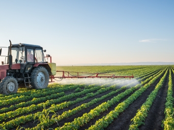 truck spraying crop with pesticides