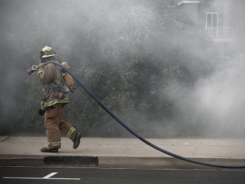 firefighter walking through smoke