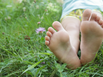 child's feet on grass