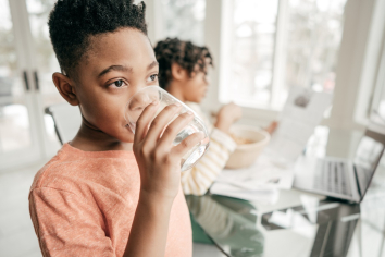 Boy drinking water: Massachusetts PFAS and your health study