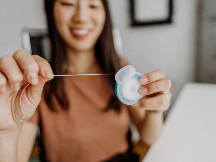 woman holding dental floss